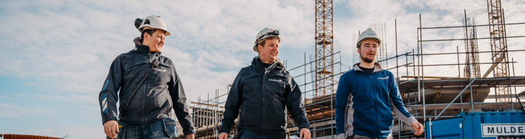 Drie vakmannen lopen op de bouwplaats in City West Nieuwegein